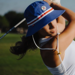 A golf hat is a type of hat that is specifically designed for playing golf. It is typically made of a lightweight, breathable material, such as cotton or mesh, and has a wide brim to protect the wearer from the sun.